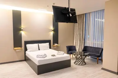 a hotel room with a bed and a table and chairs at ZOOM HOTEL in Istanbul