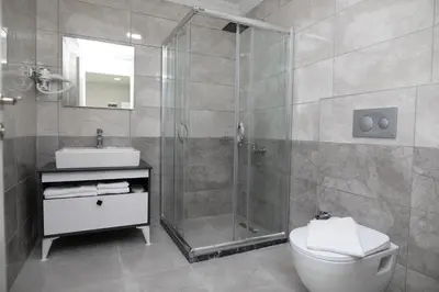 a bathroom with a shower and a toilet and a sink at ZOOM HOTEL in Istanbul