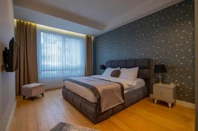 a bedroom with a large bed and a large window at Ar-mo-ni in Istanbul