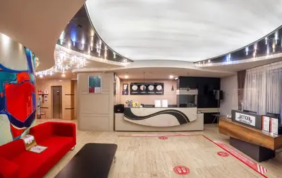 a living room with a red couch and a kitchen at Ar-mo-ni in Istanbul