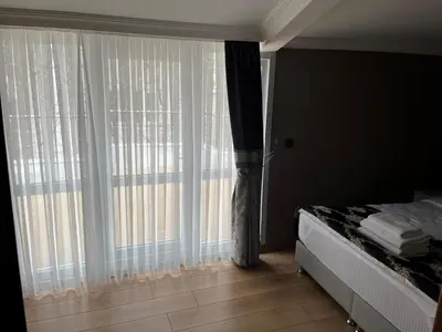 a bedroom with a bed and a large window at H&L Suites in Istanbul