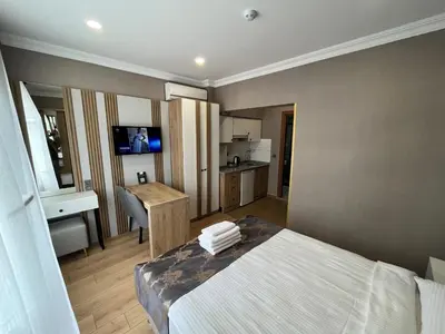 a hotel room with a bed and a kitchen at H&L Suites in Istanbul