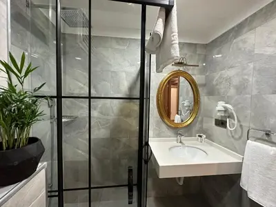a bathroom with a sink and a mirror at H&L Suites in Istanbul