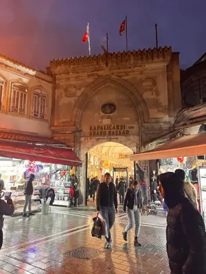 a group of people walking down a street in a market at Sami hotel in Istanbul