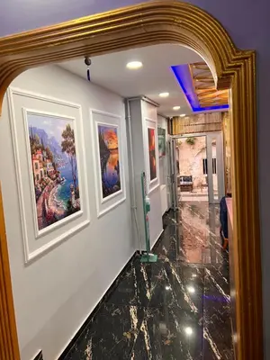 a hallway with three paintings on the wall at Sami hotel in Istanbul