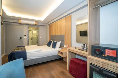 a hotel room with a bed and a tv at Hotel Martin in Istanbul