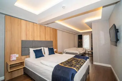 a hotel room with a bed and a television at Hotel Martin in Istanbul