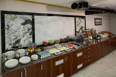 a kitchen with a buffet with plates and food at İstanbul Efes Hotel in Istanbul