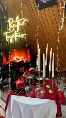 a table with candles on it with a fireplace at Yalova Kasaba Bungalov in Çınarcık