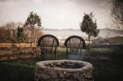 two chairs and a fire pit in a yard at Yalova Kasaba Bungalov in Çınarcık