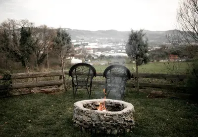 two chairs sitting next to a fire pit in a yard at Yalova Kasaba Bungalov in Çınarcık