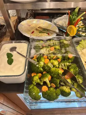 a buffet with several trays of broccoli and other foods at GROSS HOTEL in Istanbul