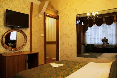 a hotel room with a bed and a mirror at GROSS HOTEL in Istanbul