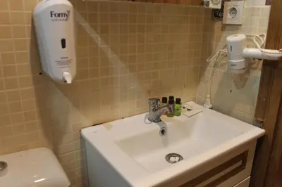 a bathroom with a sink and a hair dryer on the wall at GROSS HOTEL in Istanbul
