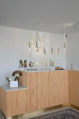 a lobby of a hotel with a chandelier at Meshk Airport Hotel in Arnavutköy