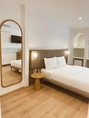 a bedroom with a bed and a large mirror at Meshk Airport Hotel in Arnavutköy