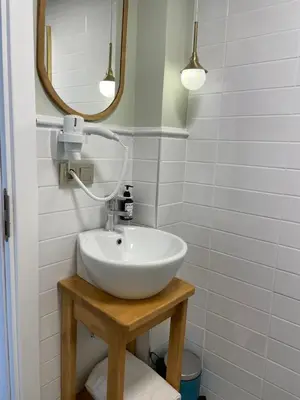 a bathroom with a white sink and a mirror at Meshk Airport Hotel in Arnavutköy