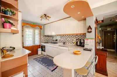 a kitchen with white cabinets and a table in it at Villa Base Kırkpınar Detached Villa with pool in Sapanca