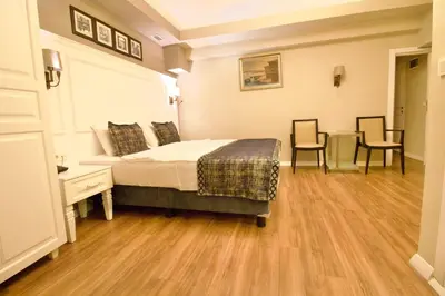 a bedroom with a bed and a table and chairs at Olympos Garden Hotel in Istanbul