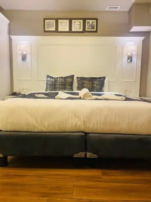 a large bed in a bedroom with two pillows at Olympos Garden Hotel in Istanbul