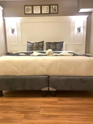 a large bed sitting in a room with at Olympos Garden Hotel in Istanbul
