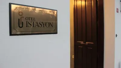 a door to a room with a sign on the wall at İstasyon Otel in Boyalık