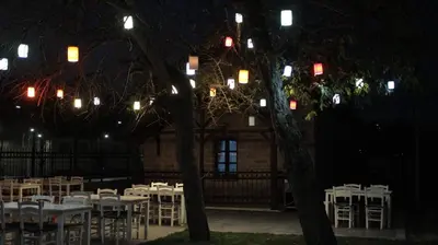 a group of tables and chairs in front of a building at İstasyon Otel in Boyalık