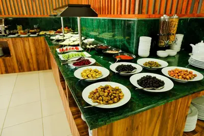 a buffet with plates of food on a counter at Velmore Hotel & Spa in Kestel