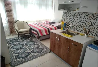 a kitchen with a sink and a bed in a room at Ceylan Köşk Apartman in Istanbul