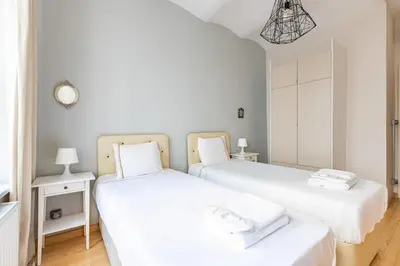 two beds in a room with white walls at Warm Cozy Charming 2BD2Bath GalataTower Gem! #256 in Istanbul