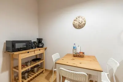 a dining room table with chairs and a clock on the wall at Warm Cozy Charming 2BD2Bath GalataTower Gem! #256 in Istanbul