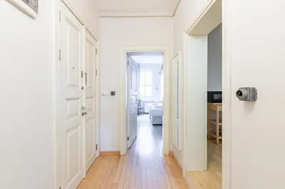 a hallway with white walls and wooden floors at Warm Cozy Charming 2BD2Bath GalataTower Gem! #256 in Istanbul