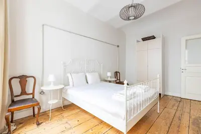 a white bedroom with a white bed and a chair at Bright Charming 2BD15Bath GalataTower Home! #257 in Istanbul