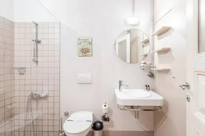 a bathroom with a sink and a toilet and a mirror at Bright Charming 2BD15Bath GalataTower Home! #257 in Istanbul
