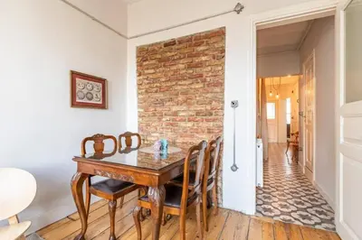 a dining room with a table and a brick wall at Bright Charming 2BD15Bath GalataTower Home! #257 in Istanbul