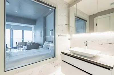 a bathroom with a sink and a large mirror at Trendy Cool Bright Studio Parking PoolViews! #254 in Istanbul
