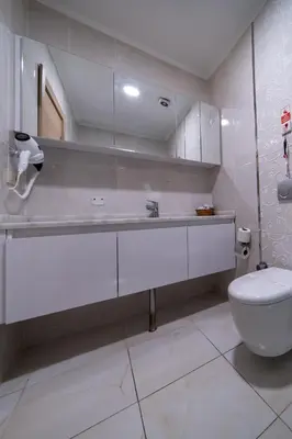 a white bathroom with a toilet and a sink at Mardy Hotel Ataturk Airport in Istanbul