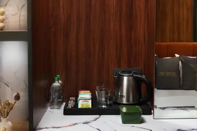 a table with a coffee pot and a drink on it at Second Suit Hotel in Istanbul