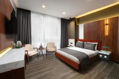 a hotel room with a bed and a table and chairs at Second Suit Hotel in Istanbul