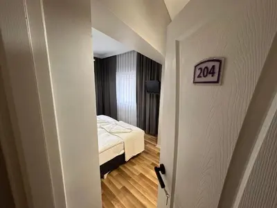 a room with a bed and a door with a sign at Asparagus HOTEL & SUITES OLD CITY in Istanbul