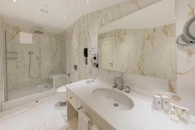 a bathroom with a sink and a shower and a toilet at Hallmark Hotel & SPA Istanbul in Istanbul