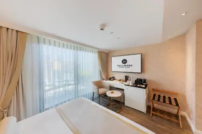 a hotel room with a bed and a desk and a window at Hallmark Hotel & SPA Istanbul in Istanbul
