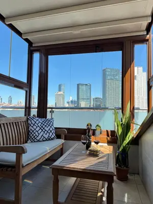 a living room with a couch and a table at Kaplan Luxury Family Flat - 3 Bedrooms with air conditioning & heating in the City in Istanbul