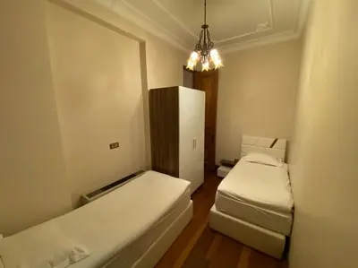 a small room with two beds and a mirror at Aslan Residence in Istanbul