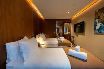 a hotel room with two beds and a television at Kate Hotel Special Class & SPA in Istanbul
