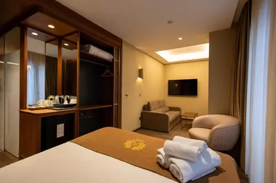 a hotel room with a bed and a chair at Kate Hotel Special Class & SPA in Istanbul