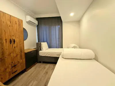 a small room with two beds and a window at Halij suite in Istanbul