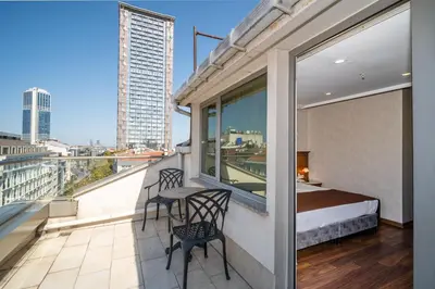 a balcony with a bed and a table and chairs at Hotel Blisstanbul in Istanbul