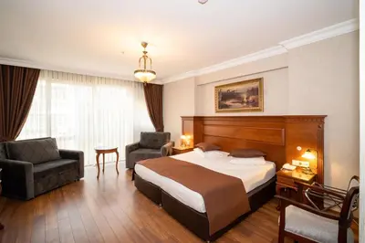 a hotel room with a bed and two chairs at Hotel Blisstanbul in Istanbul