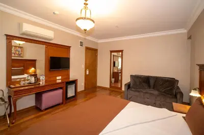 a hotel room with a bed and a couch and a television at Hotel Blisstanbul in Istanbul